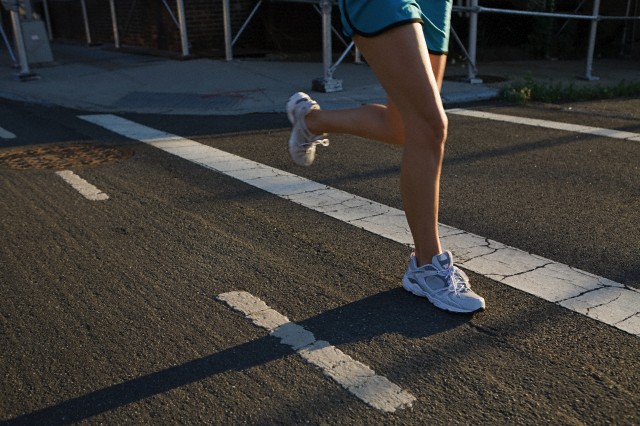 Legs of runner on road